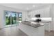 Modern kitchen features an island, granite countertops, and stainless steel appliances at 1133 Red Buckeye Ct, Deland, FL 32720