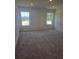 Bright bedroom with neutral carpet and two windows letting in natural light at 1145 Red Buckeye Ct, Deland, FL 32720