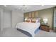 Well-lit bedroom with modern chandelier, comfortable bed, side tables and decorative wall art at 1145 Red Buckeye Ct, Deland, FL 32720