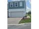 Charming two-story townhouse with a paved driveway and attached two-car garage at 1145 Red Buckeye Ct, Deland, FL 32720
