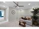 Relaxing living area featuring a comfortable sofa, ceiling fan, decorative plant and neutral tones at 1145 Red Buckeye Ct, Deland, FL 32720