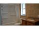 Bathroom with a tile shower and tub combination, and a wooden vanity with sink at 1315 Veech Rd, Leesburg, FL 34748
