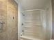 Modern bathroom with tile walls, a bathtub, a shower head, and built-in shelves at 1315 Veech Rd, Leesburg, FL 34748