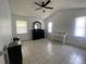 Bright bedroom featuring neutral colors, with tile floors, a ceiling fan, and great natural light at 1315 Veech Rd, Leesburg, FL 34748
