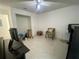 Bedroom area with a neutral color scheme, tile floors, and a ceiling fan at 1315 Veech Rd, Leesburg, FL 34748
