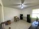 Bedroom area with a neutral color scheme, tile floors, and a ceiling fan at 1315 Veech Rd, Leesburg, FL 34748