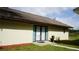 Exterior of home featuring a covered entryway with double doors, and a well-manicured lawn at 1315 Veech Rd, Leesburg, FL 34748