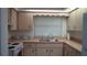 Kitchen featuring cream cabinets, a white range, and a double-bowl sink at 1315 Veech Rd, Leesburg, FL 34748