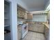 Kitchen featuring cream cabinets, a white range, and a double-bowl sink at 1315 Veech Rd, Leesburg, FL 34748