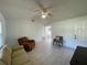Living room with tile floors, a ceiling fan, and neutral-colored furniture at 1315 Veech Rd, Leesburg, FL 34748