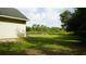 Wide yard with lush green lawn and adjacent tree line, perfect for enjoying nature at 1315 Veech Rd, Leesburg, FL 34748