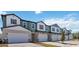 Charming townhomes featuring modern architecture, individual driveways, and attached garages at 2465 Magnolia Reserve Rd, Ocoee, FL 34761