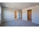 Empty main bedroom featuring carpeted floors, neutral walls, and dual closets at 572 Highfalls Ave, Debary, FL 32713