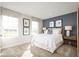 Bright bedroom with large windows, a blue accent wall, and neutral carpet flooring at 6408 Domizio Dr, Winter Haven, FL 33884