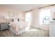 Charming bedroom with a pink color scheme, featuring large windows and soft, natural light at 6408 Domizio Dr, Winter Haven, FL 33884