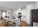Open-concept kitchen featuring white cabinets, stainless steel appliances, granite countertops and breakfast bar seating at 6408 Domizio Dr, Winter Haven, FL 33884