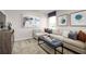 Bright living room features a comfortable sectional sofa, modern decor, and large picture window at 6408 Domizio Dr, Winter Haven, FL 33884