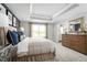 This spacious main bedroom features a tray ceiling, large window, ensuite, and neutral-toned walls at 6408 Domizio Dr, Winter Haven, FL 33884