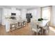 Modern kitchen with an island, breakfast bar, stainless appliances, and an adjacent dining area at 6501 Domizio Dr, Winter Haven, FL 33884