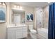 Clean bathroom with white vanity, shower-tub combo, and decorative artwork at 6505 Domizio Dr, Winter Haven, FL 33884
