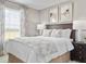 Inviting bedroom with large window, framed art, and dark wood furniture at 6505 Domizio Dr, Winter Haven, FL 33884