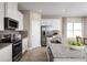 Modern kitchen with stainless steel appliances, granite countertops, and an island with seating at 6505 Domizio Dr, Winter Haven, FL 33884