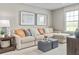 Cozy living room with comfortable sectional sofa, neutral tones, and a large window at 6505 Domizio Dr, Winter Haven, FL 33884