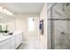 Elegant bathroom featuring a double vanity, tiled shower, and neutral color palette for a soothing experience at 6524 Domizio Dr, Winter Haven, FL 33884