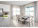 Bright dining area featuring a modern table set, natural light, and access to the patio at 6524 Domizio Dr, Winter Haven, FL 33884