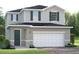 Charming two-story home with gray siding, black shutters, and a two-car garage at 6524 Domizio Dr, Winter Haven, FL 33884
