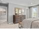 Cozy main bedroom with a large dresser, a bench, carpeted floors and a sunlit window view at 6524 Domizio Dr, Winter Haven, FL 33884