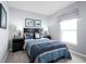 Cozy bedroom with a dark wood furniture, featuring blue bedding, coordinating lamps, and a calm serene atmosphere at 6528 Domizio Dr, Winter Haven, FL 33884