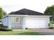 Charming single-story home with a two-car garage, landscaped front yard, and covered entry way at 6528 Domizio Dr, Winter Haven, FL 33884
