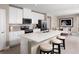 Stylish kitchen featuring white cabinets, an island with seating, stainless steel appliances, and a connected dining area at 6528 Domizio Dr, Winter Haven, FL 33884