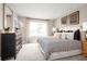 Serene main bedroom with elegant decor, a comfortable bed, soft lighting, and a large window at 6528 Domizio Dr, Winter Haven, FL 33884
