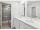 Modern bathroom featuring double sinks, a walk-in shower, and ample storage space at 5281 Luisa Ct, St Cloud, FL 34771