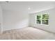 Bedroom with neutral carpet and large window showcasing the natural outdoor scenery at 5281 Luisa Ct, St Cloud, FL 34771