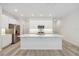 Modern kitchen featuring white cabinetry, stainless steel appliances, and a large center island at 5281 Luisa Ct, St Cloud, FL 34771