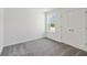 Cozy bedroom with plush carpet, a window providing natural light, and a spacious closet at 5285 Luisa Ct, St Cloud, FL 34771