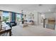 Spacious living space with a cozy sofa, workspace, stylish decor, and access to an adjacent hallway and other rooms at 823 Emerald Grove Dr, Apopka, FL 32703