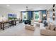 Versatile living space with comfortable seating, multiple workstations, ample lighting, and views of the outdoors at 823 Emerald Grove Dr, Apopka, FL 32703