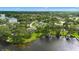 Aerial view of a home near a lake surrounded by trees, with a pool and enclosed patio at 1148 Rosetta Dr, Deltona, FL 32725