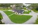 An aerial view of a home on a corner lot with lush landscaping near a lake at 1148 Rosetta Dr, Deltona, FL 32725
