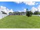 Expansive backyard with lush lawn and a screened-in patio area, great for outdoor living at 1148 Rosetta Dr, Deltona, FL 32725