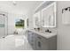 Luxurious bathroom with marble floors, a freestanding tub, dual vanity, and a frameless glass shower at 1148 Rosetta Dr, Deltona, FL 32725