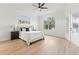 Spacious bedroom with ample natural light features wood floors, ceiling fan, and access to the outdoor area at 1148 Rosetta Dr, Deltona, FL 32725