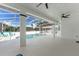 A covered outdoor patio with ceiling fans overlooks a refreshing pool and serene backyard at 1148 Rosetta Dr, Deltona, FL 32725