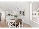 Open dining area with modern light fixture connects seamlessly to the kitchen, perfect for Gathering meals at 1148 Rosetta Dr, Deltona, FL 32725