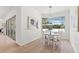 Sunlit dining area with sliding glass doors and pool view, features modern light fixture and stylish decor at 1148 Rosetta Dr, Deltona, FL 32725