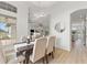 Open dining area with wood floors, seating for six, and views of the living room and kitchen at 1148 Rosetta Dr, Deltona, FL 32725